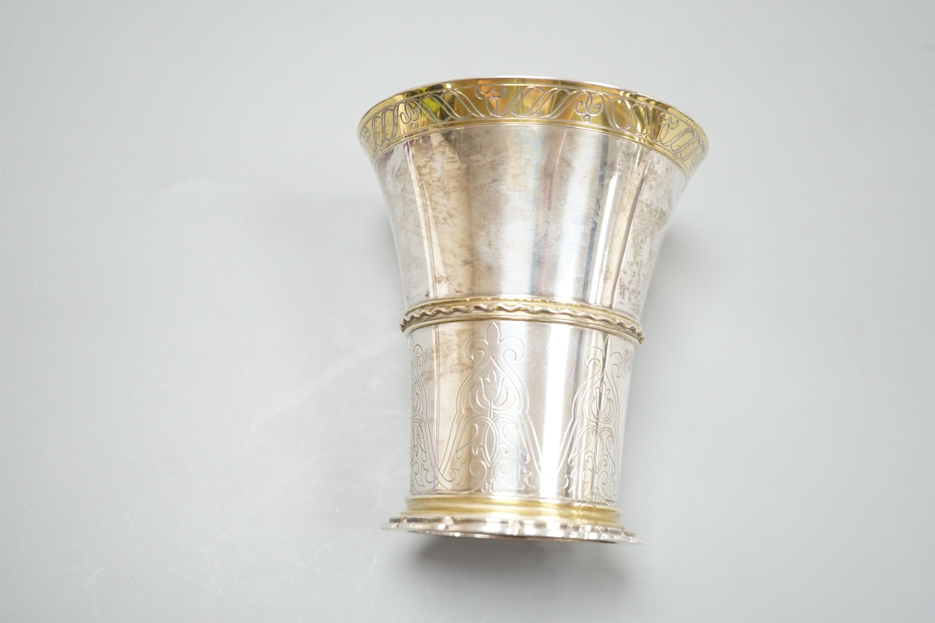 A German 800 standard parcel gilt white metal beaker, by Tezler, 10cm, 207 grams.